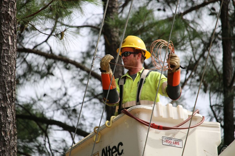 Electric lineworker in a bucket truck