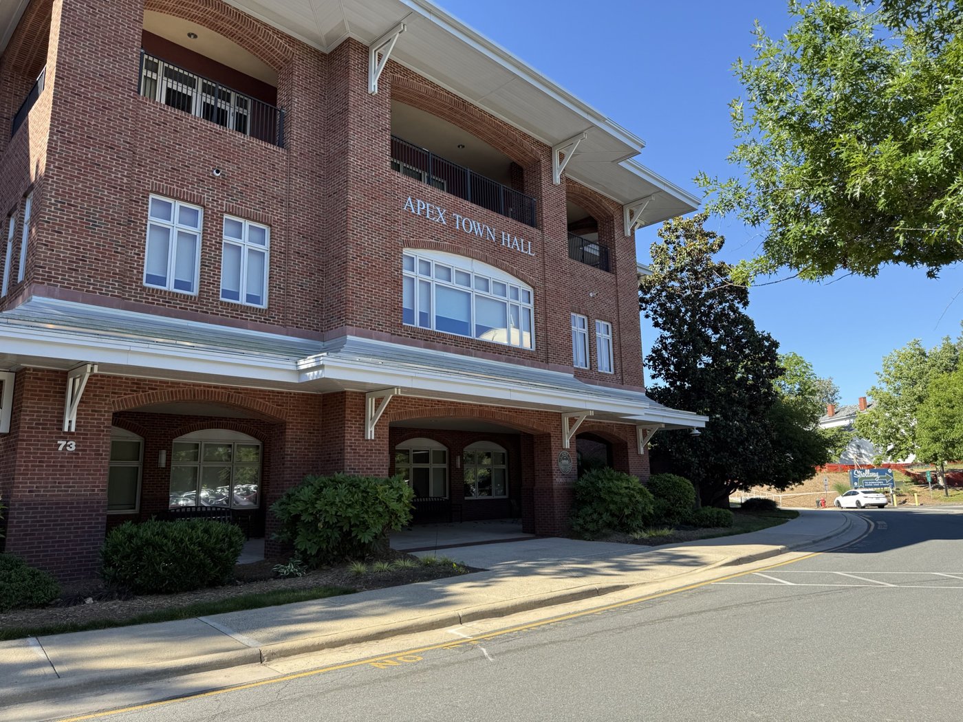 Apex Town Hall, a brick building on Hunter Street, on a sunny day