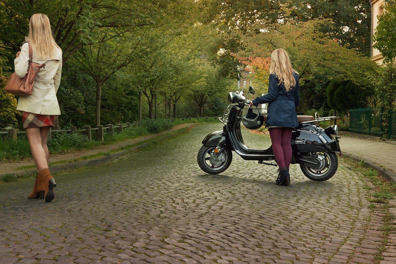 Seated electric motor scooter